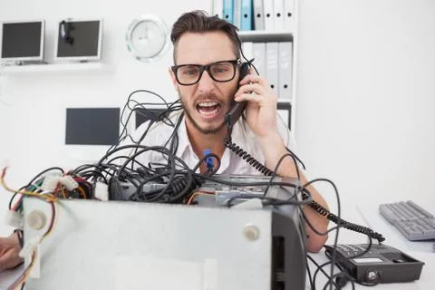 Angry computer engineer making a call Stock Photos