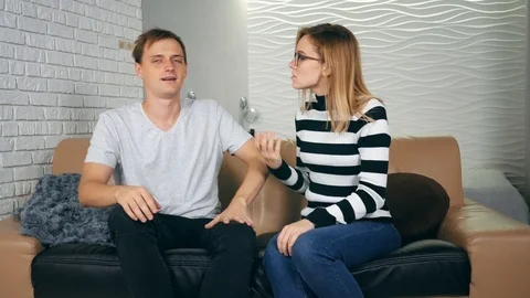Angry couple breaking up on a couch in the night at home. The couple has a co 動画素材 121503588