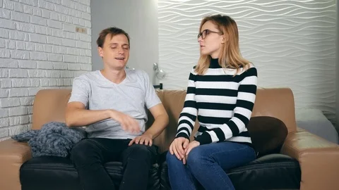 Angry couple breaking up on a couch in the night at home. The couple has a co 스톡 동영상 121503668