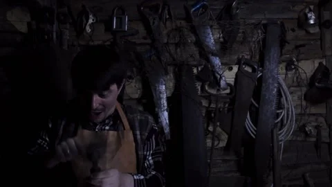 Angry crazy maniac plays with sharp weapons and laughs in the old house. copy Stock Footage 140108549