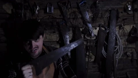 Angry crazy maniac with rusty saw in an old house Video stock 135655035