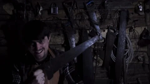 Angry crazy maniac with rusty saw in an old house. copy space 動画素材 136442826