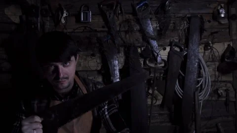 Angry crazy maniac with rusty saw in an old house. copy space Stock Footage 140108703