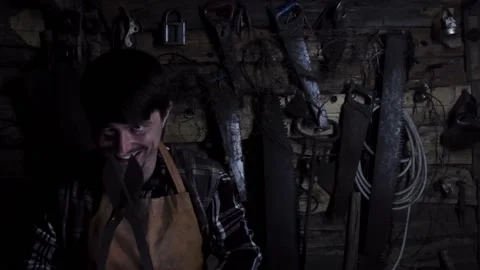 Angry crazy maniac with rusty sicator in an old house Stock-Footage 135655023