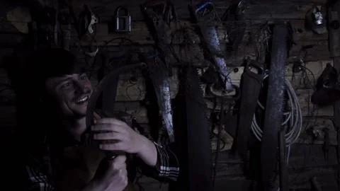 Angry crazy maniac with rusty sickle in an old house Stock Footage 135655106