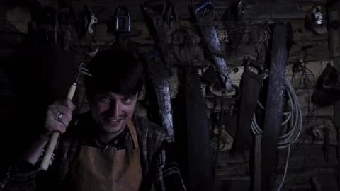 Angry crazy maniac with a sharp weapon in an old house 動画素材 135655012