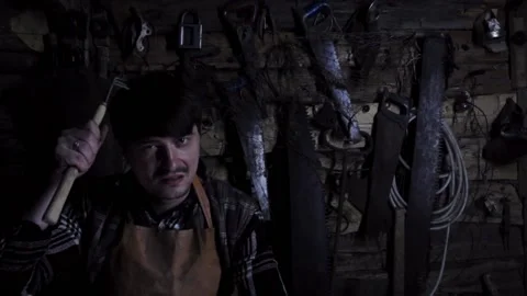 Angry crazy maniac with a sharp weapon in an old house Stock Footage 136442675