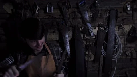 Angry crazy maniac sharpens rusty knives in an old house. copy space Stock-Footage 137970743