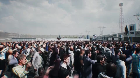 Angry crowd protesting AI near a data center,Robot carrying weapon, anti-AI Stock Footage 336346103