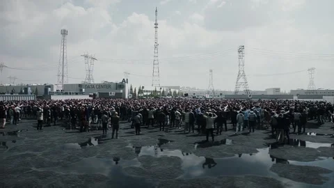 Angry crowd protesting AI near a data center,Robot carrying weapon, anti-AI Stock Footage 336346111