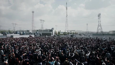 Angry crowd protesting AI near a data center,Robot carrying weapon, anti-AI Stock Footage 336346123