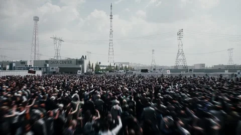 Angry crowd protesting AI near a data center,Robot carrying weapon, anti-AI Stock Footage 336346127