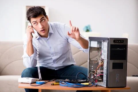 Angry customer trying to repair computer with phone support 写真素材