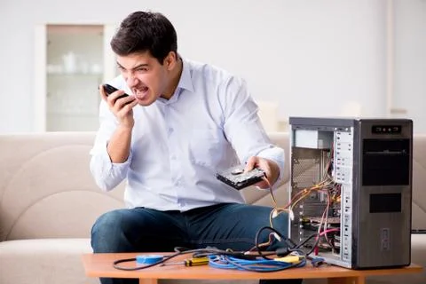 Angry customer trying to repair computer with phone support 库存照片
