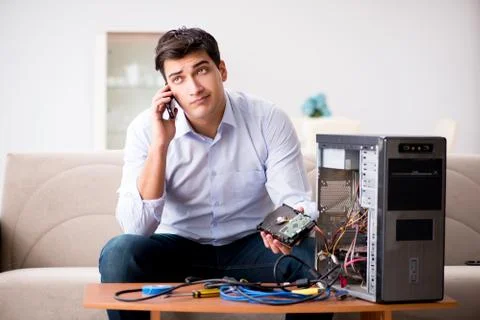 Angry customer trying to repair computer with phone support 写真素材