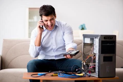 Angry customer trying to repair computer with phone support 스톡 사진