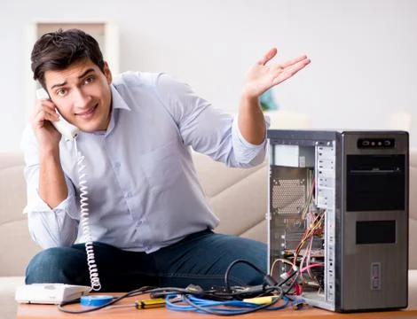 Angry customer trying to repair computer with phone support 库存照片