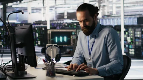 Angry data center engineer banging fist on desk after seeing system failure Stock Footage 309618931