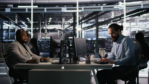 Angry data center engineer banging fist on desk after seeing system failure Stock Footage 309625079