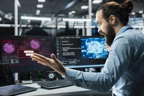 Angry data center engineer raging, struggling to fix malfunctions while using AI Stock Photos