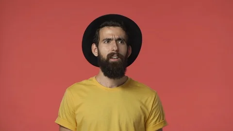 Angry devastated middle-eastern jewish guy with beard in black hat, yellow t Stock Footage 115777723