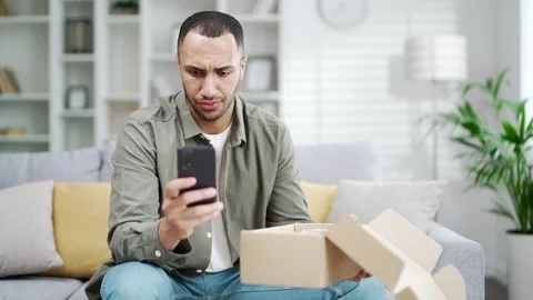 Angry dissatisfied client arabian man receive broken carton bad parcel delivery  Stock Footage 247073703