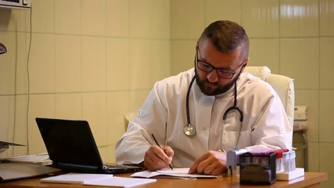 Angry doctor writing the prescription and giving to the patient Stock Footage