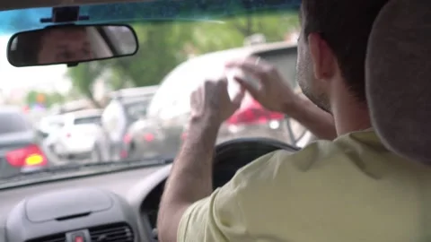 Angry driver in a car in a traffic jam. Unhappy man in a traffic jam Vidéo 197247040