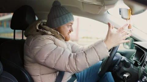 Angry driver in a traffic jam. He screams and Stock Footage 234137054