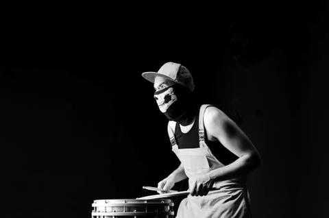 Angry drummer on a black background Foto stock