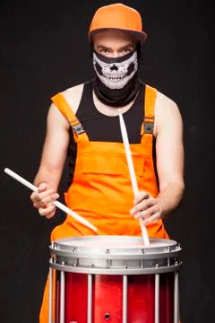 Angry drummer on a black background Stock Photos