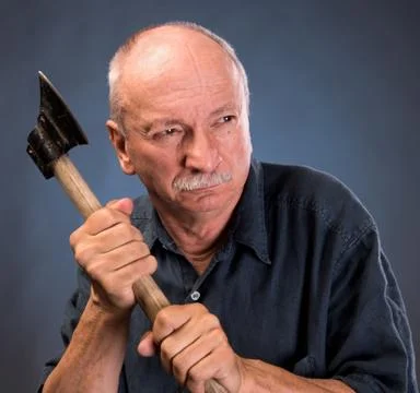 Angry elderly man with an ax Stock Photos