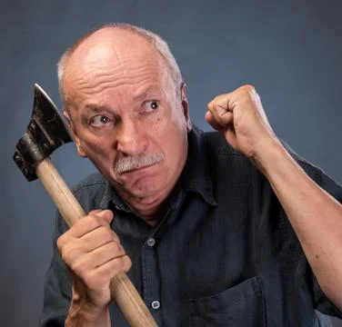 Angry elderly man with an ax Stock Photos