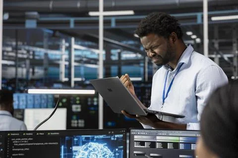 Angry engineer in AI data center annoyed by errors affecting equipment 스톡 사진