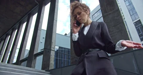 Angry female office worker in a formal clothes outdoors checking smartwatch Video stock 137160053