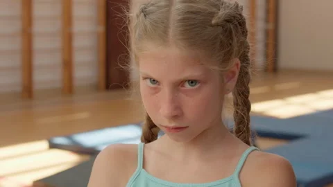 Angry girl looking at camera close up sad frustrated offended child kid pupil 動画素材 306862570