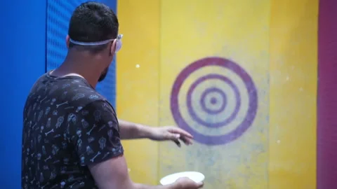 Angry guy in dash throws ceramic plate slowmotion at target. Rage and anger. Video stock 102560534