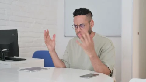 Angry Hispanic Man Sitting in Office Video stock 307906949