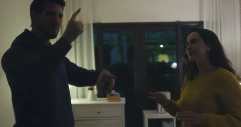 Angry Hispanic young couple arguing and pointing fingers in dark home. Vidéo 344106445