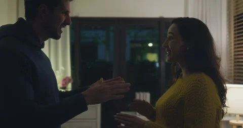 Angry Hispanic young couple arguing and pointing fingers in dark home. Видео 344106468