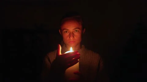 Angry homeowner using candles during power outage. Blackout in Ukraine. Stock Footage 229479380