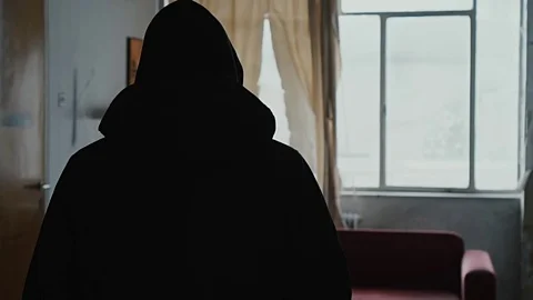 Angry hooded young man inside dark derelict ghetto building apartment,slowmo Video stock 72556538