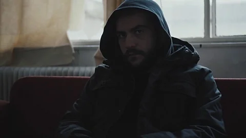 Angry hooded young man inside dark derelict ghetto building apartment,slowmo Vídeos de archivo 72560644