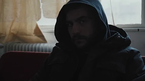 Angry hooded young man inside dark derelict ghetto building apartment,slowmo Vídeos de archivo 72560914