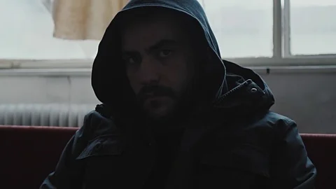 Angry hooded young man inside dark derelict ghetto building apartment,slowmo Vídeos de archivo 72561333