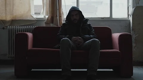 Angry hooded young man inside dark derelict ghetto building apartment,slowmo Vídeos de archivo 72561842