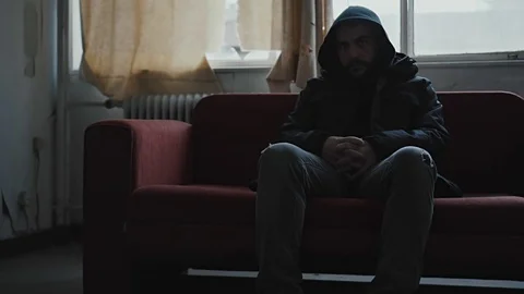 Angry hooded young man inside dark derelict ghetto building apartment,slowmo Vídeos de archivo 72561995