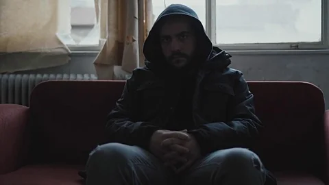 Angry hooded young man inside dark derelict ghetto building apartment,slowmo Vídeos de archivo 72562162