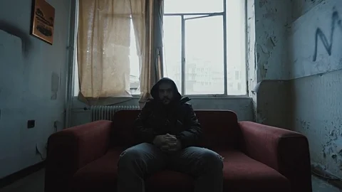 Angry hooded young man inside dark derelict ghetto building apartment,slowmo Vídeos de archivo 72564742