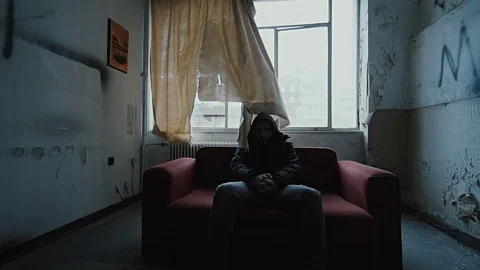 Angry hooded young man inside dark derelict ghetto building apartment,slowmo Vídeos de archivo 72565853